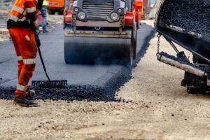 Construction workers paving a road